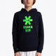 Boy wearing the Osaka kids hoodie in navy with green star logo. Front view