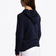 Girl wearing the Osaka kids hoodie in navy with green star logo. Side/back view
