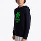 Boy wearing the Osaka kids hoodie in navy with green star logo. Front/side view