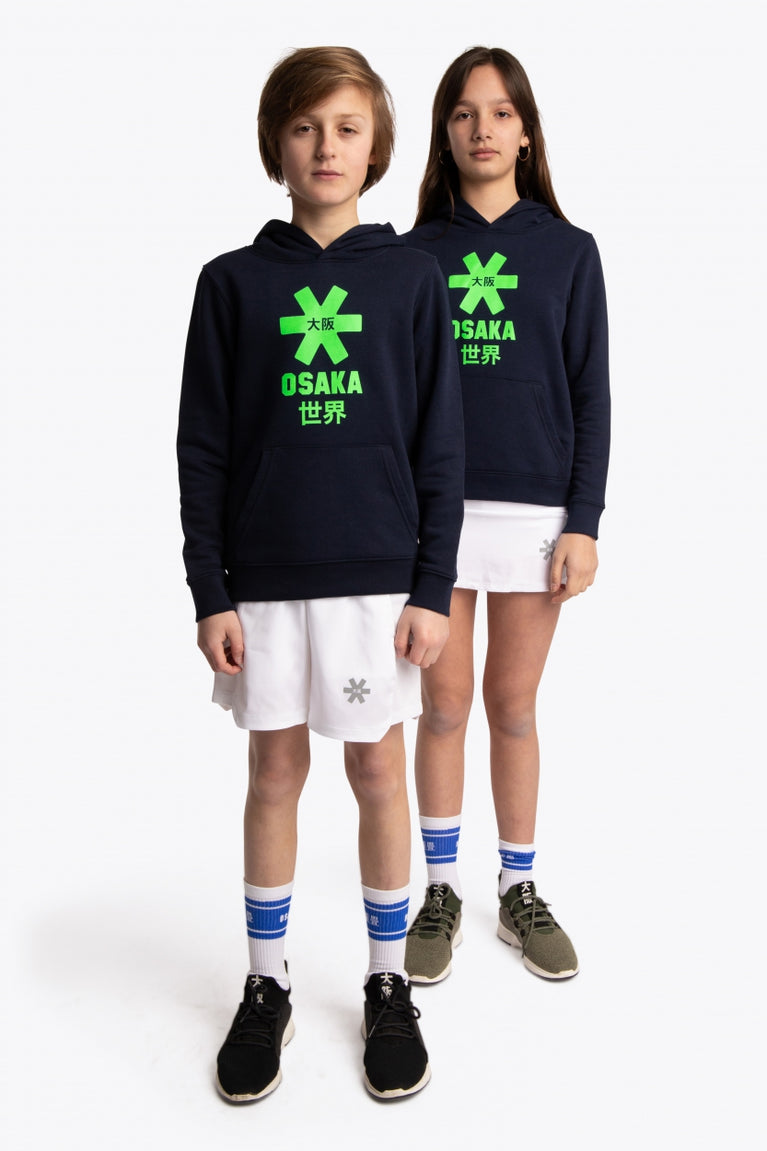 Boy and girl wearing the Osaka kids hoodie in navy with green star logo. Front full view