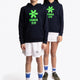Boy and girl wearing the Osaka kids hoodie in navy with green star logo. Front full view
