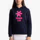 Girl wearing the Osaka kids hoodie in navy with pink star logo. Front view