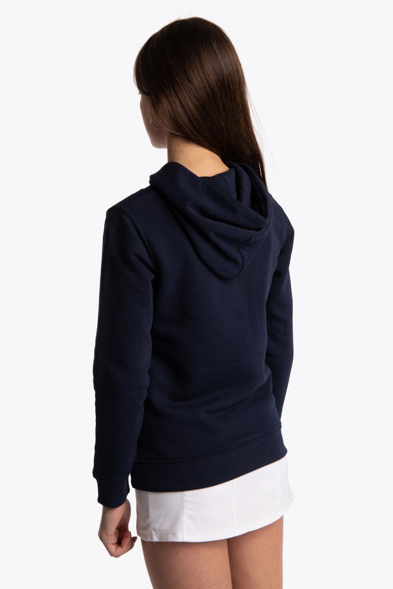 Girl wearing the Osaka kids hoodie in navy with pink star logo. Back/side view