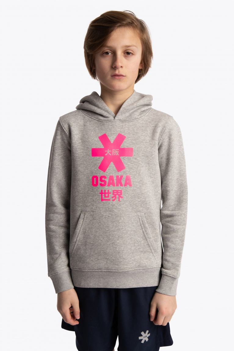 Boy wearing the Osaka kids hoodie in grey with pink star logo. Front view