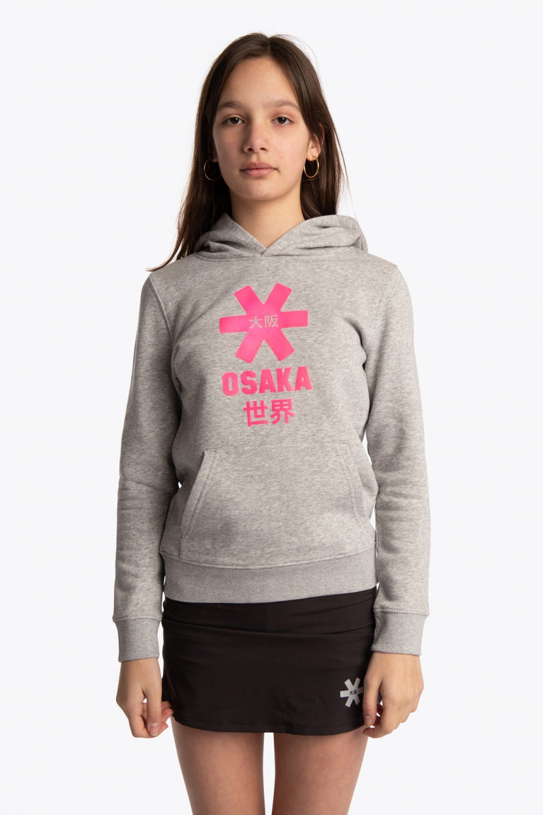 Girl wearing the Osaka kids hoodie in grey with pink star logo. Front view