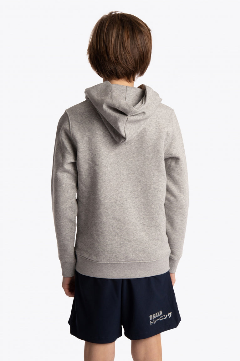 Boy wearing the Osaka kids hoodie in grey with pink star logo. Back view