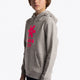 Boy wearing the Osaka kids hoodie in grey with pink star logo. Front/side view