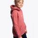 Girl wearing the Osaka kids trace hoodie in cranberry with logo in white and blue. Side/front view