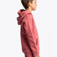 Boy wearing the Osaka kids trace hoodie in cranberry with logo in white and blue. Side view
