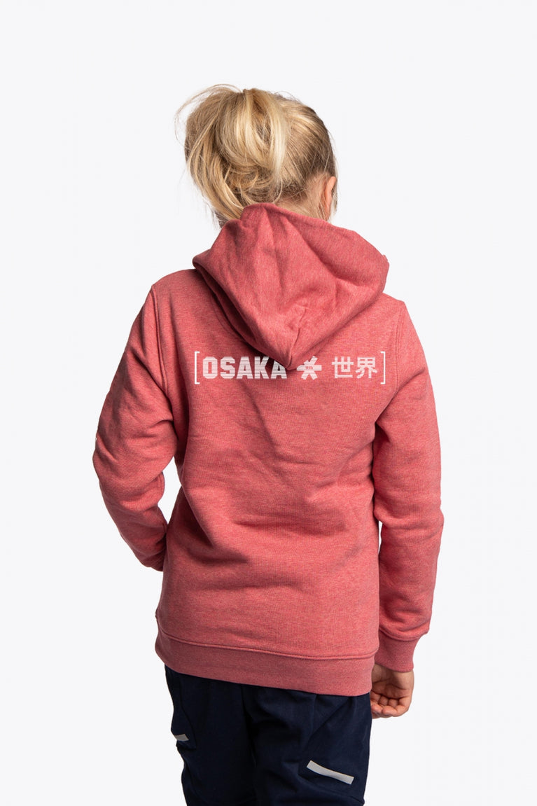 Girl wearing the Osaka kids trace hoodie in cranberry with logo in white and blue. Back view