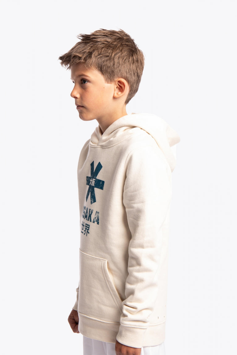 Boy wearing the Osaka kids vintage hoodie in natural raw with logo in blue. Front/side view