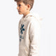 Boy wearing the Osaka kids vintage hoodie in natural raw with logo in blue. Front/side view
