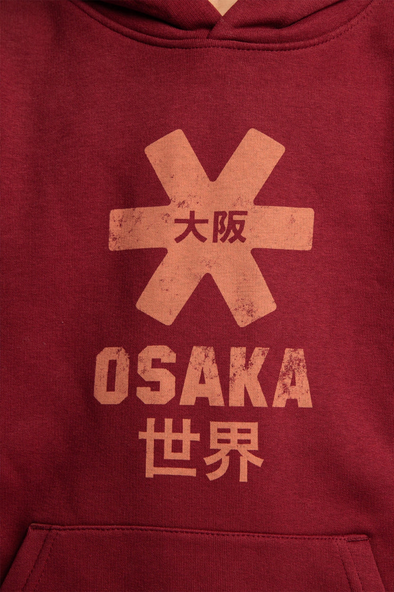 Osaka kids vintage hoodie in burgundy with logo in orange. Detail view logo