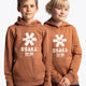 Boy and girl wearing the Osaka kids vintage hoodie in caramel with logo in white. Front view