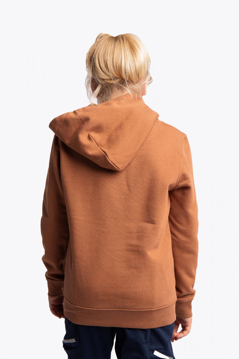 Girl wearing the Osaka kids vintage hoodie in caramel with logo in white. Back view