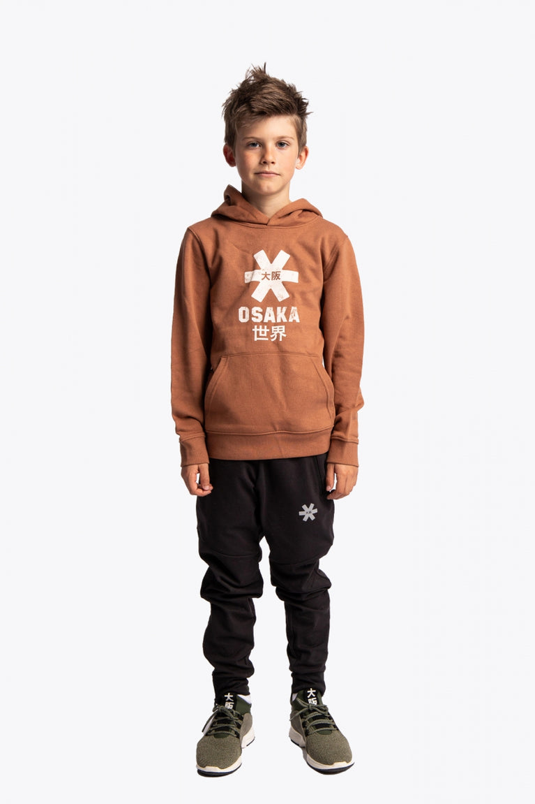 Boy wearing the Osaka kids vintage hoodie in caramel with logo in white. Front full view