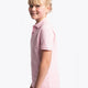 Girl wearing the Osaka kids polo in cotton pink with logo in white. Side view