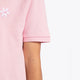 Osaka kids polo in cotton pink with logo in white. Detail view shoulder