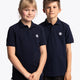 Boy and girl wearing the Osaka kids polo in navy with logo in white. Front view