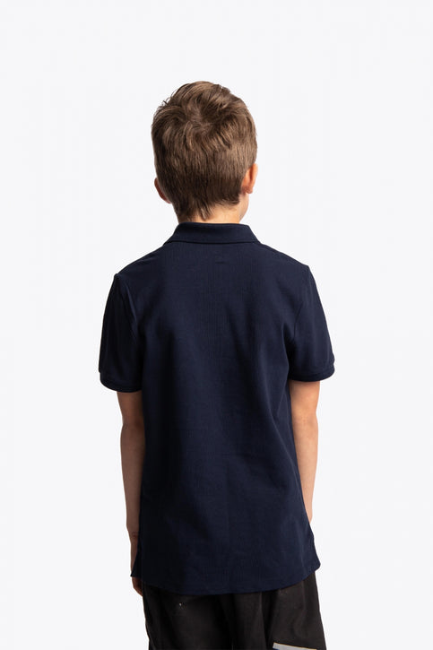 Boy and girl wearing the Osaka kids polo in navy with logo in white. Front view