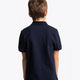 Boy wearing the Osaka kids polo in navy with logo in white. Back view