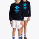 Boy and girl wearing the Osaka kids sweater in navy with logo in blue. Front full view