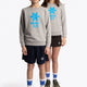 Boy and girl wearing the Osaka kids sweater in grey with logo in blue. Front full view