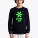 Boy wearing the Osaka kids sweater in navy with logo in green. Front view