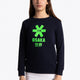 Girl wearing the Osaka kids sweater in navy with logo in green. Front view