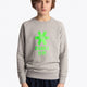Boy wearing the Osaka kids sweater in grey with logo in green. Front view