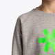 Osaka kids sweater in grey with logo in green. Detail view shoulder