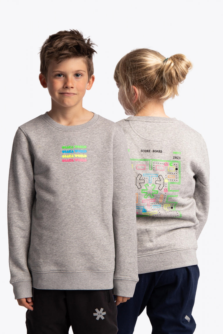 Boy and girl wearing the Osaka kids pacs sweater in navy with multicolor logo pac-man style. Front view