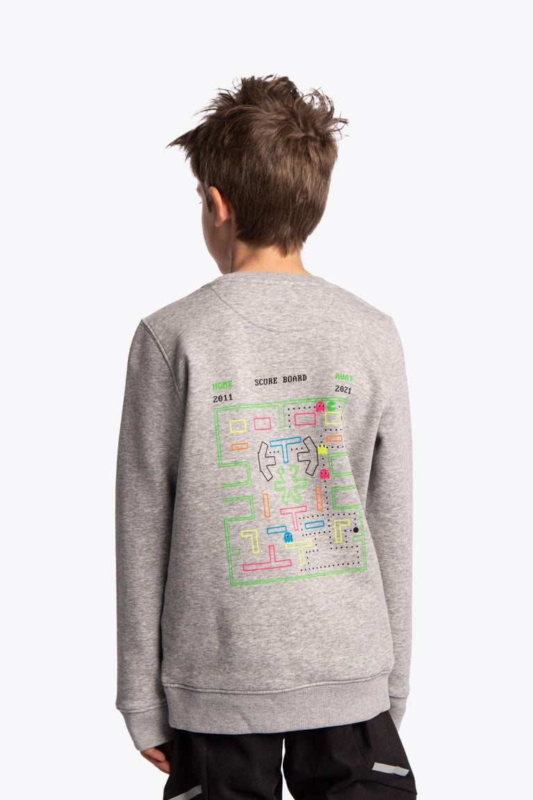 Boy wearing the Osaka kids pacs sweater in navy with multicolor logo pac-man style. Back view
