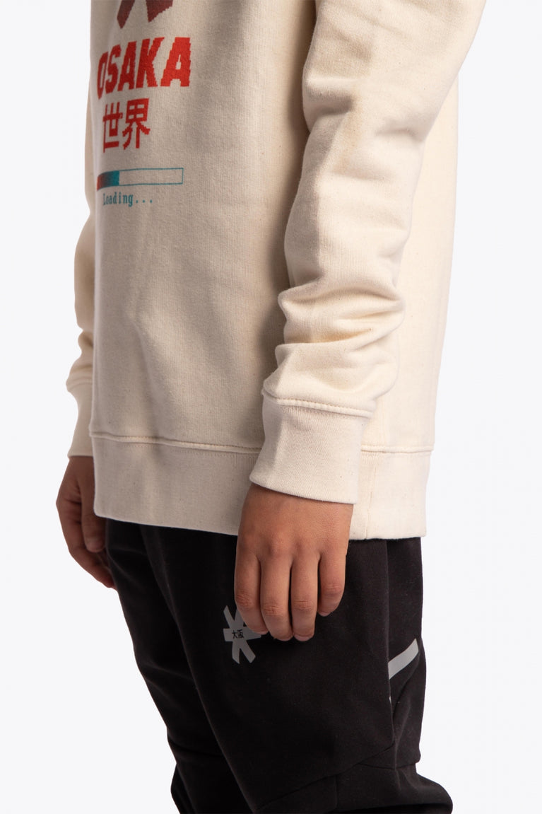 Osaka kids pixo sweater in natural raw with orange and blue logo. Detail view sleeve