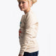 Girl wearing the Osaka kids pixo sweater in natural raw with orange and blue logo. Side view