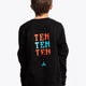 Boy wearing the Osaka kids pixo sweater in black with orange and blue logo. Back view