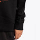 Osaka kids pixo sweater in black with orange and blue logo. Detail view sleeve