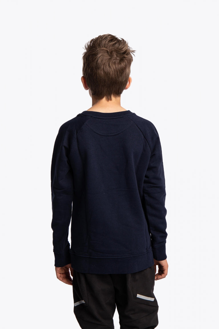 Boy wearing the Osaka kids worldcup sweater in navy with orange logo. Back view