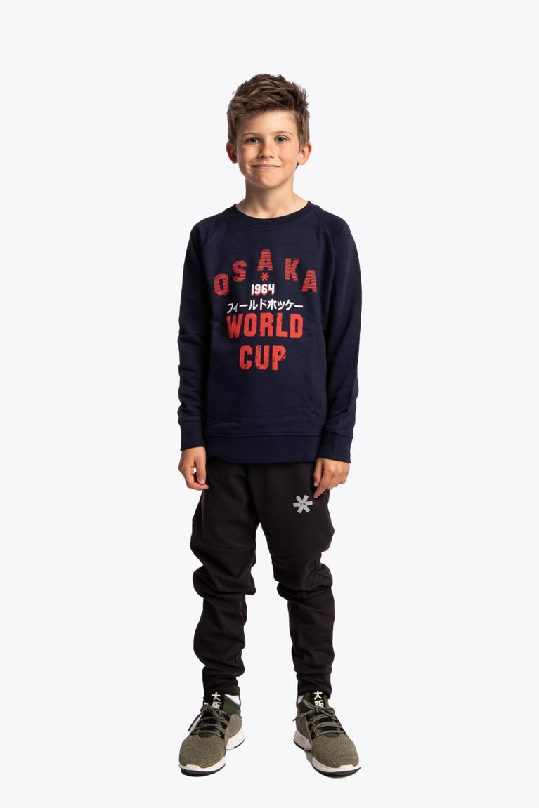 Boy wearing the Osaka kids worldcup sweater in navy with orange logo. Front full view
