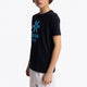 Boy wearing the Osaka kids tee short sleeve navy with logo in blue. Front/side view