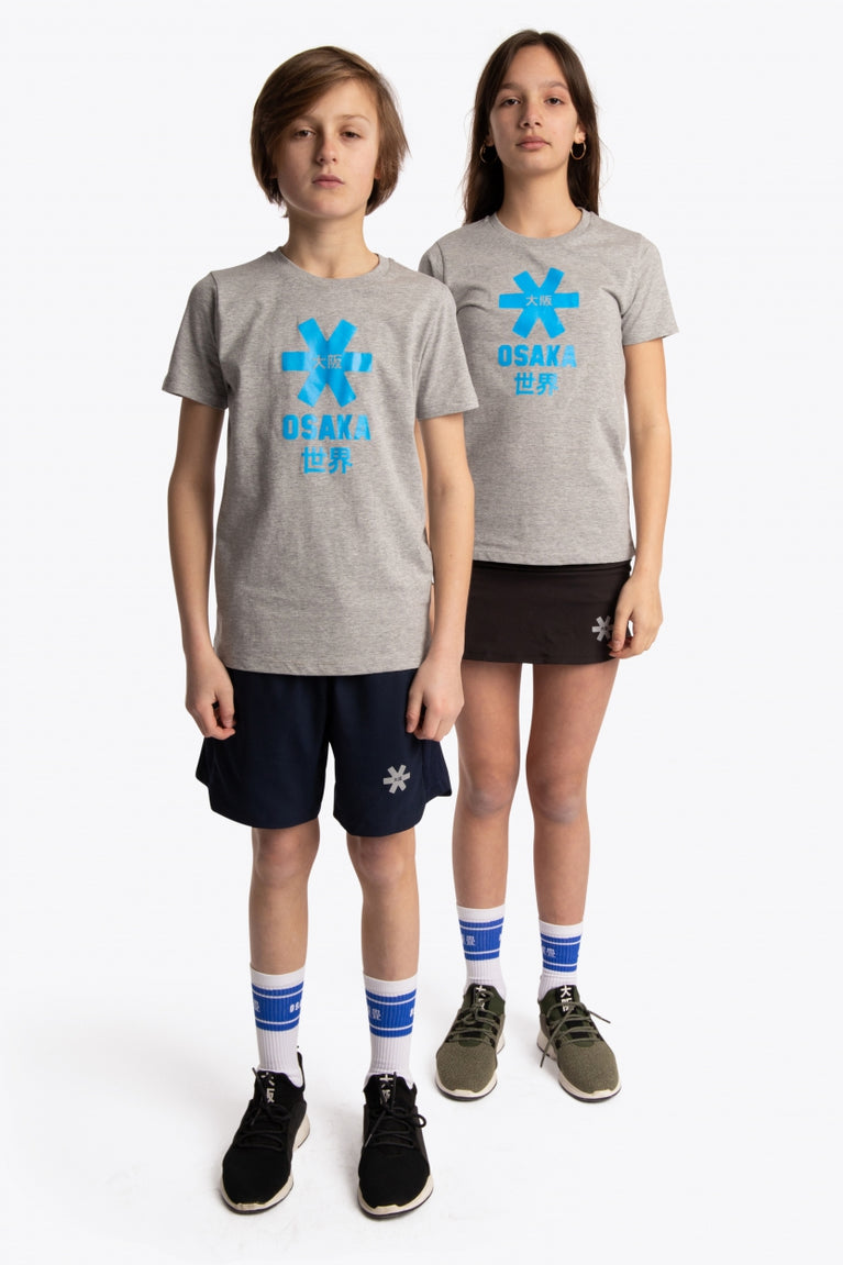 Boy and girl wearing the Osaka kids tee short sleeve grey with logo in blue. Front full view