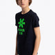 Boy wearing the Osaka kids tee short sleeve navy with logo in green. Front view