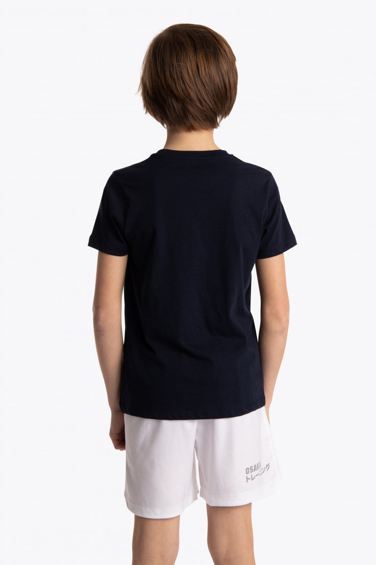 Boy wearing the Osaka kids tee short sleeve navy with logo in green. Back view