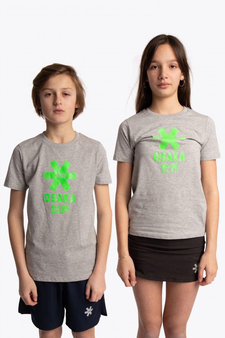 Boy and girl wearing the Osaka kids tee short sleeve grey with logo in green. Front view