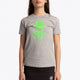 Girl wearing the Osaka kids tee short sleeve grey with logo in green. Front view