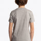 Boy wearing the Osaka kids tee short sleeve grey with logo in green. Back view