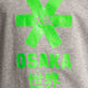 Osaka kids tee short sleeve grey with logo in green. Detail view logo