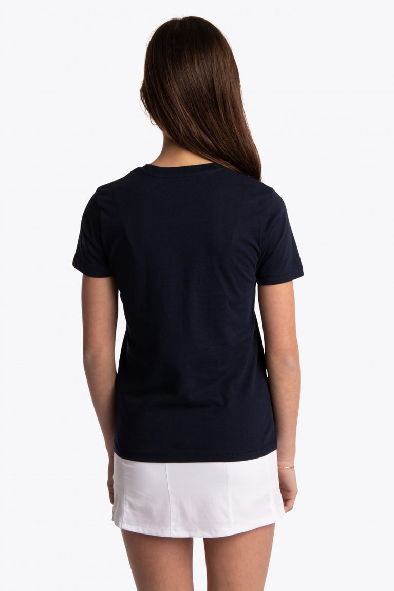 Girl wearing the Osaka kids tee short sleeve navy with logo in pink. Back view