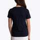 Girl wearing the Osaka kids tee short sleeve navy with logo in pink. Back view