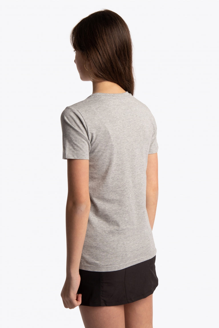 Girl wearing the Osaka kids tee short sleeve grey with logo in pink. Side view